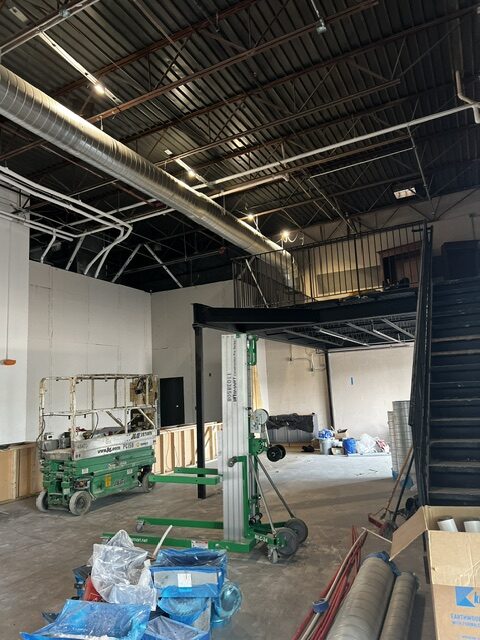 Spiral duct main running the length of a warehouse ceiling